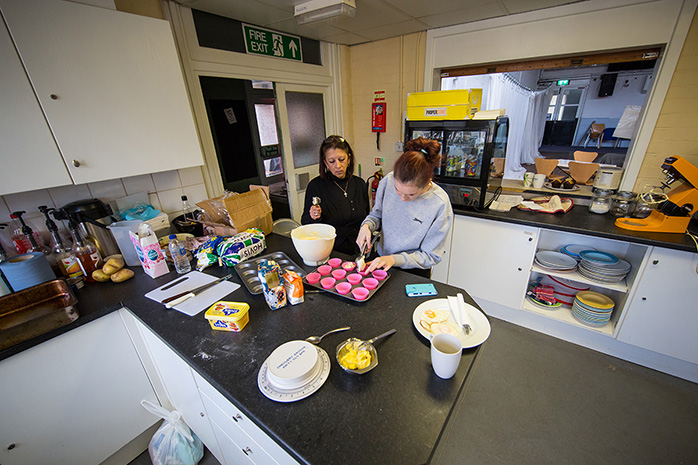 Two ladies cooking in a kitchen