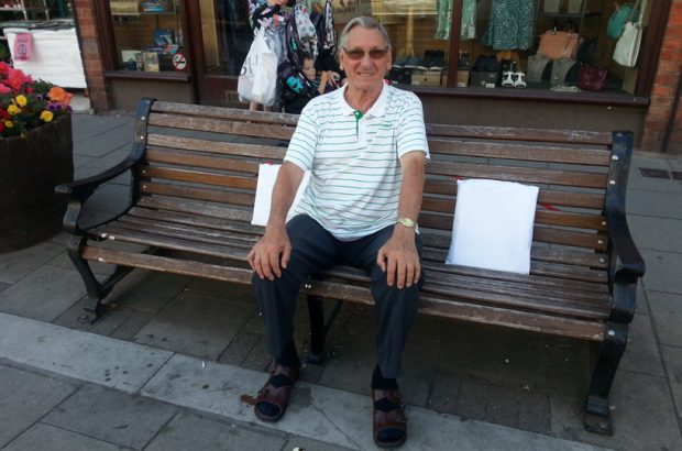 Craft group member sitting on a cushioned bench