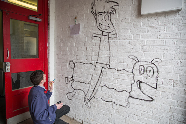 Aiden painting a mural