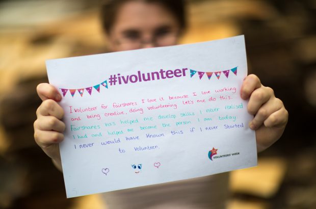 Courtney holding a sign on why she volunteers