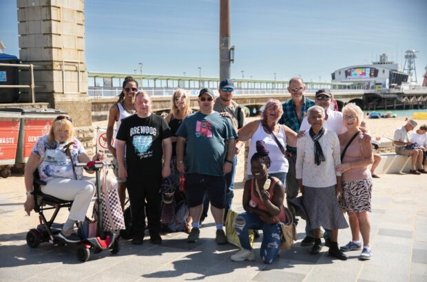 Group of participants near the pier, smiling at the camera.