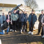 A group photo of young people smiling at our allotment.