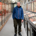 Pete smiling at the camera amongst museum exhibits.