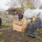 Some Spirax Sarco volunteers moving soil from the plant beds to make room for new wooden borders.