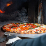 Pizza being taken out of our pizza oven at the allotment.