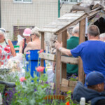 A long queue of people at our allotment waiting for burgers.