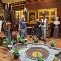 Rachel and some participants looking at an indoor display in the main hall.