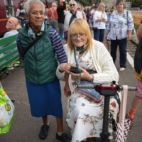 Two participants posing for the camera together as they wait for the train to arrive.