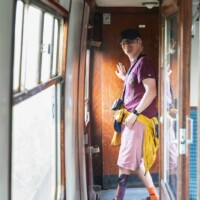 A participant smiling as he leaves one of the trains cabins.