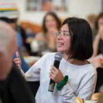 A female participant smiling as she talks about her experience with Fair Shares.