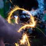 A long exposure photo of a sparkler making waves of sparks.