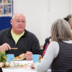 Some participants sat down at a table, eating and chatting.