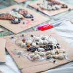 Multiple animal templates that kids have glued beans on to and have been left to wait for the glue to dry.