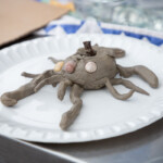 Some sort of clay octopus creature with shells for eyes.