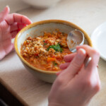 A close up of a bowl full of soup made from nearly stale bread.