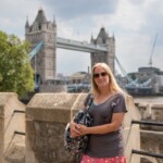 A photo of Rachel stood on the walls of the Tower of London, overlooking the bridge in the background.