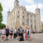 A group photo of staff and young people standing outside the White Tower.
