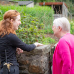 A participant chatting with a member of staff at St Fagans.